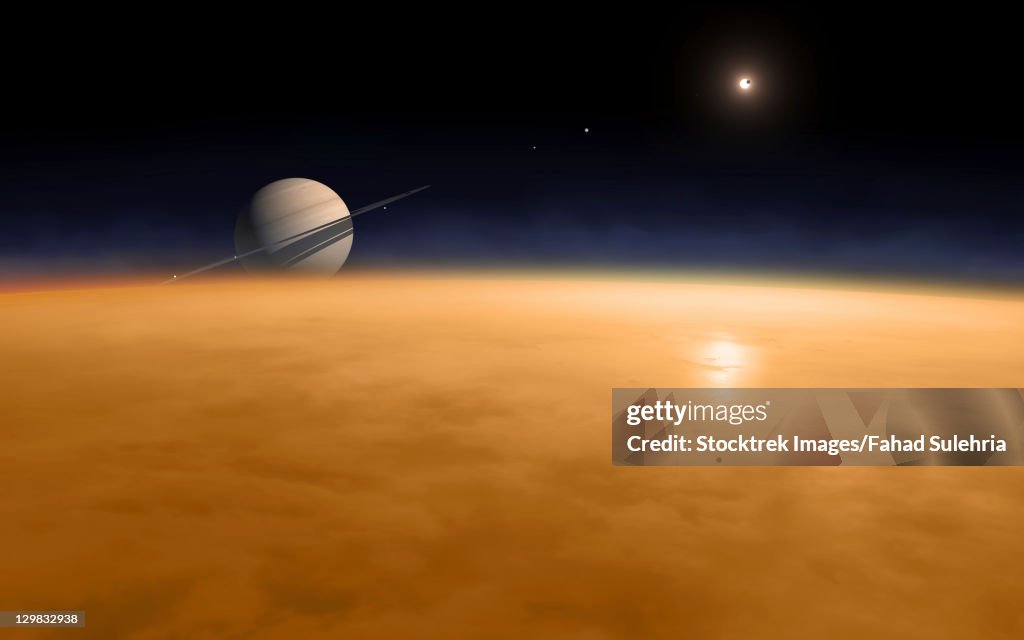 Saturn above the thick atmosphere of its moon Titan.