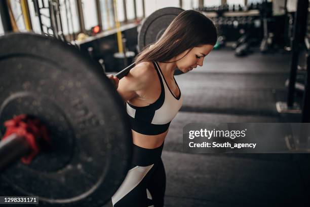 fit woman training with weights in gym - women's weightlifting stock pictures, royalty-free photos & images