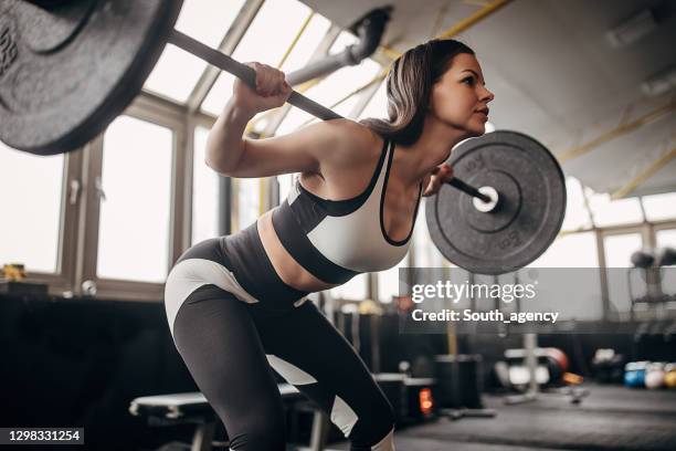 fit woman training with weights in gym - women's weightlifting stock pictures, royalty-free photos & images