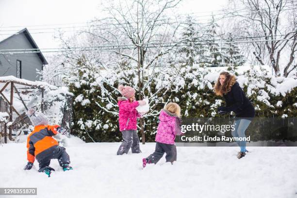 family playing in the snow - father and mother with their daughter playing in the snow stock pictures, royalty-free photos & images