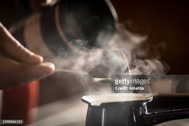 close-up of a man preparing coffee in coffee pot on stove - ground coffee stock pictures, royalty-free photos & images