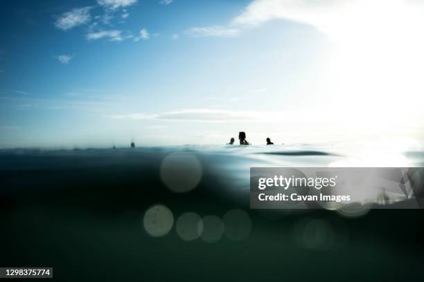 surfer waiting for the series with the calm sea - tabla stock pictures, royalty-free photos & images