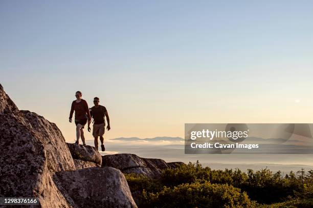 male and female hiker walk along appalachian trail in mountains, maine - 悪地地形 ストックフォトと画像