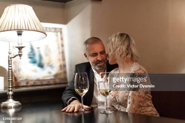 lovey couple drinks wine in the stylish restaurant - ideal wife stock pictures, royalty-free photos & images