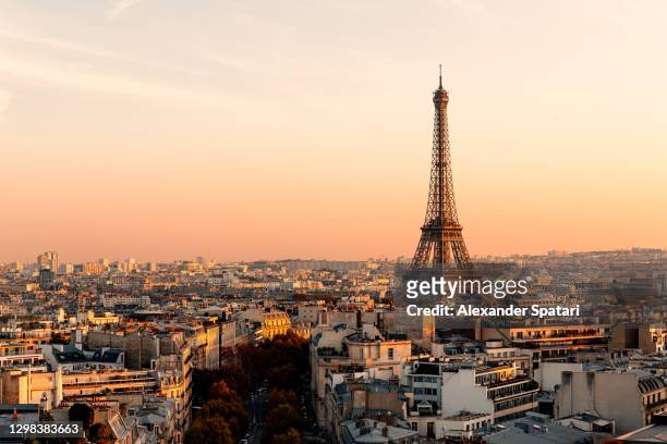 aerial view of paris streets and eiffel tower at sunset, france - paris stock-fotos und bilder