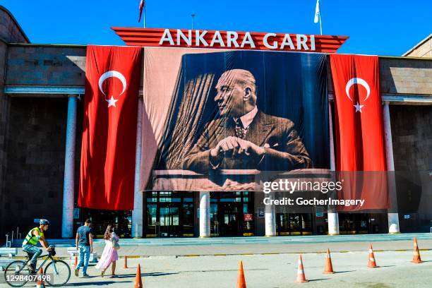 Turkish national flags and a portrait of modern Turkey's founder Mustafa Kemal Ataturk are hung on the facade of the old central train station during...