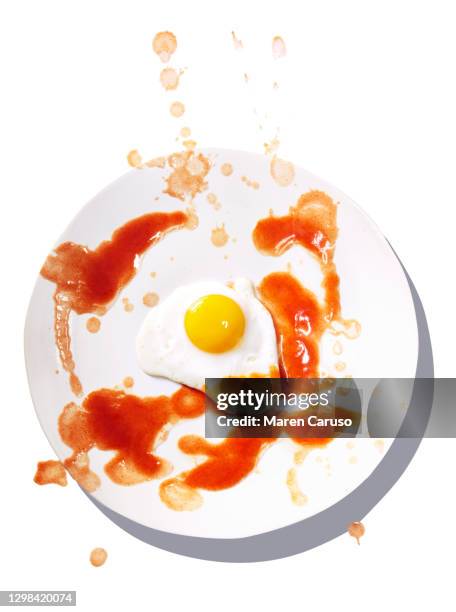 fried egg on white plate - sauce splatter stock pictures, royalty-free photos & images