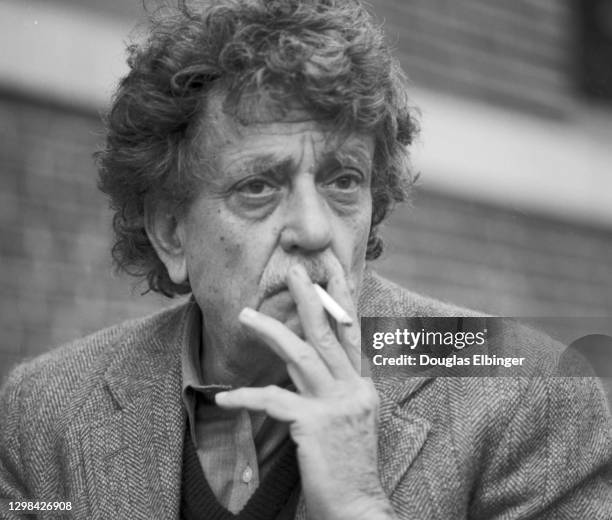 View of American author Kurt Vonnegut Jr as he smokes a cigarette outside the Michigan State University Student Union, East Lansing, Michigan, April...
