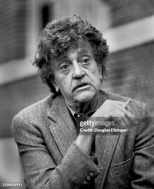 View of American author Kurt Vonnegut Jr as he smokes a cigarette outside the Michigan State University Student Union, East Lansing, Michigan, April...