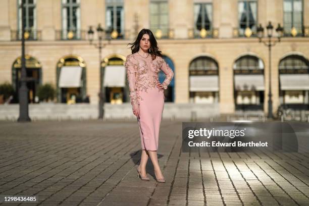 Sara Carnicella wears a golden necklace, a pink dress with mesh lace and floral embroidery from Tony Ward, Valentino studded high heels pointy shoes,...