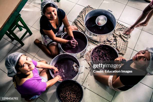 The girls prepare Acai juice, which grows abundantly in this region of Brazil.