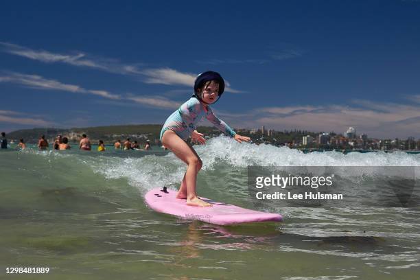 The photographer's daughter surfs a wave at Freshwater Beach on January 26, 2021 in Sydney, Australia. The Bureau of Meteorology has forecast severe...