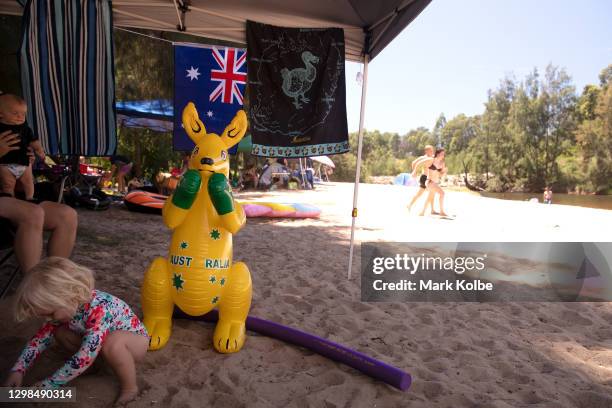An inflatable boxing kangaroo is seen under a family's shade at the Nepean River Reserve in Menangle Park on January 26, 2021 in Sydney, Australia....