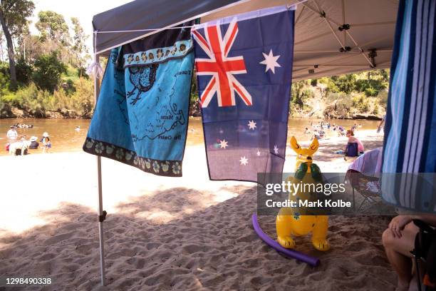 An inflatable boxing kangaroo is seen under a family's shade at the Nepean River Reserve in Menangle Park on January 26, 2021 in Sydney, Australia....