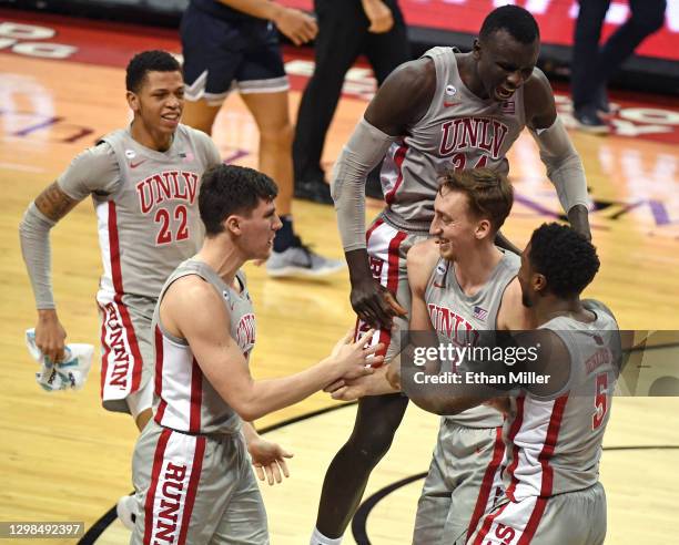 Nicquel Blake, Caleb Grill, Cheikh Mbacke Diong, Moses Wood and David Jenkins Jr. #5 of the UNLV Rebels celebrate on the court after Wood blocked a...