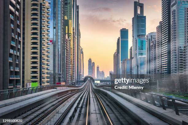 futuristic mega city dubai at sunrise united arab emirates - dubai metro stock pictures, royalty-free photos & images