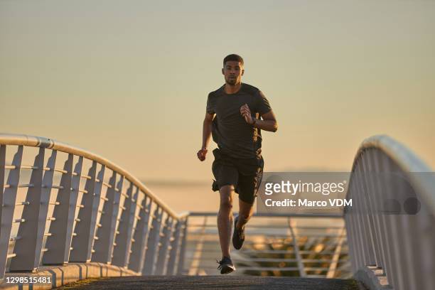 putting some power into his strides - better view sunset stock pictures, royalty-free photos & images
