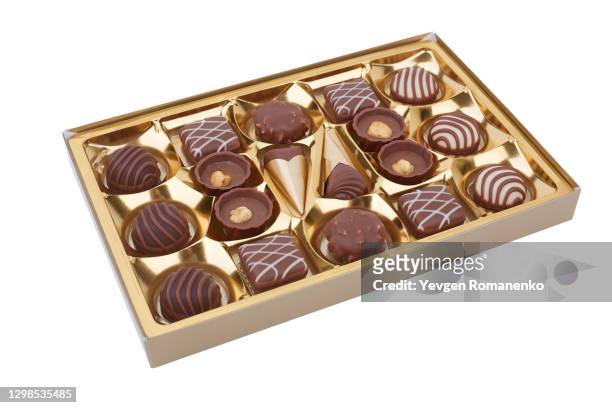 chocolate candies in a box isolated on white background - belgian culture stock pictures, royalty-free photos & images