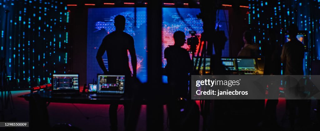 Movie set in silhouettes. Large screen with projection in background