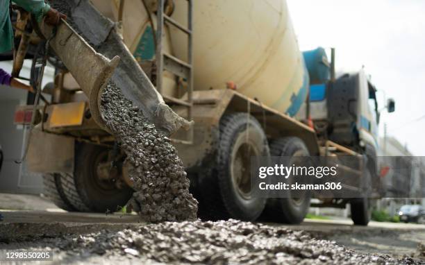 close up worker working and under construction building with cement truck - cement mixer truck stock pictures, royalty-free photos & images