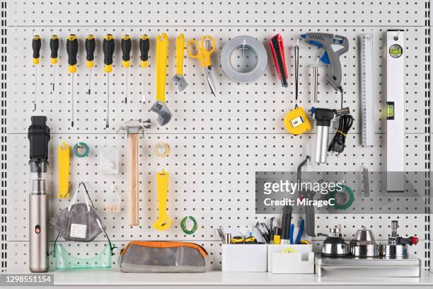 hand tools hanging on pegboard with space - tools stock-fotos und bilder