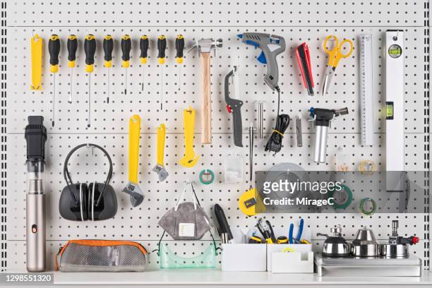 hand tools hanging on white pegboard - knolling tools stock pictures, royalty-free photos & images