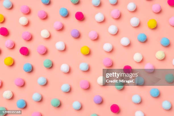 small pom-pom balls spotted pattern - pompon stock-fotos und bilder