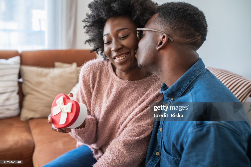 Romantic man giving a love present to his girlfriend