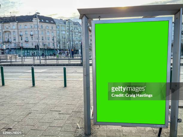 european city centre bus and tram station with advertising billboard green screen chromakey copy space - placard stock-fotos und bilder