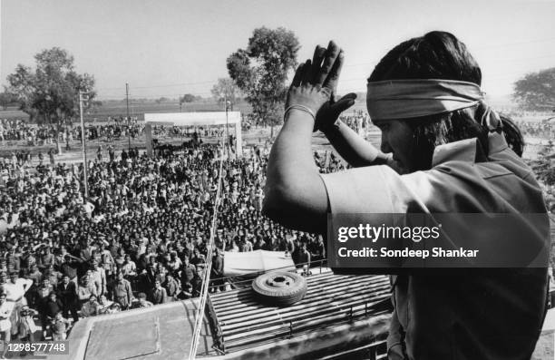 "Bandit queen" Indian rights activist, bandit and politician Phoolan Devi greets her well wishers standing on the roof of a bus she was travelling in...