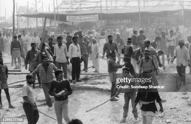 Bajrang Dal workers carrying sticks chase media persons out of the area surrounding Babri Masjid in Ayodhya on December 06, 1992 shortly before the...