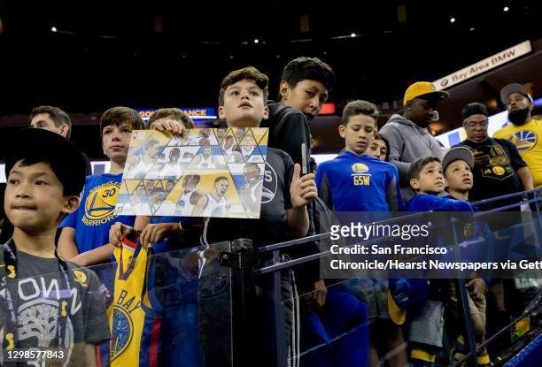Young fans wait along the player's tunnel to receive autographs before the Golden State Warriors and Toronto Raptors face off in Game 3 of the NBA...