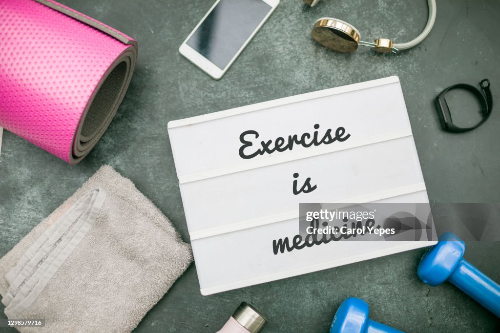 Exercise is medicine message in lightbox with gym items around