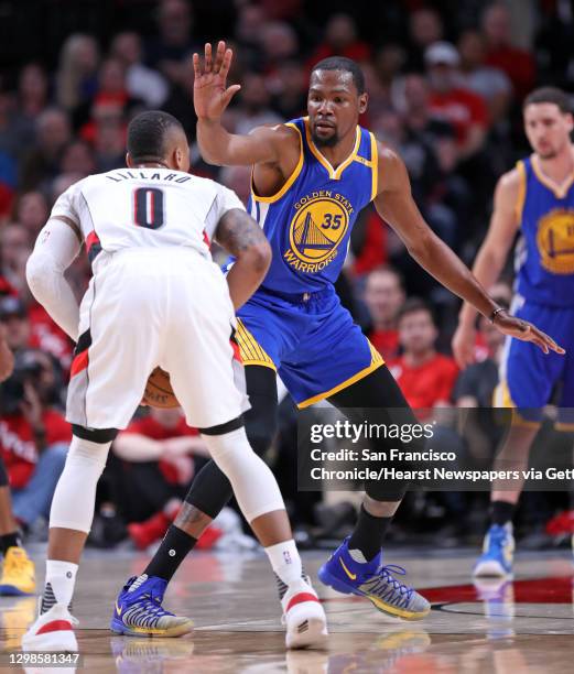 Golden State Warriors' Kevin Durant guards Portland Trail Blazers' Damian Lillard in 1st quarter in Game 4 of NBA Western Conference 1st Round...