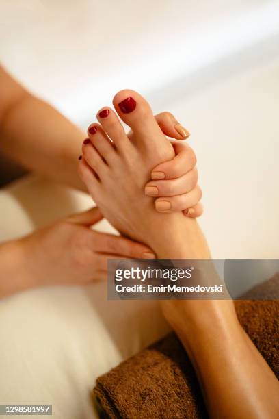 young woman having relaxing foot massage in beauty salon - foot spa stock pictures, royalty-free photos & images