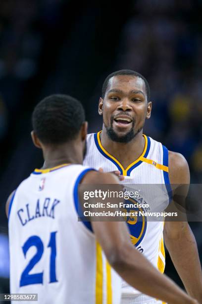 Golden State Warriors forward Kevin Durant celebrates a score with Golden State Warriors guard Ian Clark during the second half of an NBA basketball...