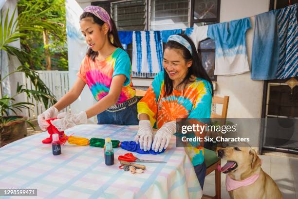 アジアの母と娘は自宅でネクタイ染料の服を作ることを楽しむ - tie dye ストックフォトと画像