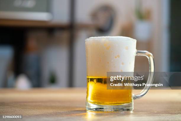 glass of light beer on the wooden table - thick glasses stock pictures, royalty-free photos & images