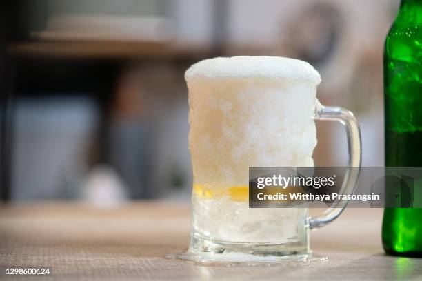glass of light beer on the wooden table - thick glasses stock pictures, royalty-free photos & images