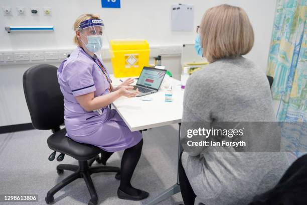 Charlene Macdonald from Washington is briefed by a member of the medical staff before receiving her AstraZeneca/Oxford University Covid-19 Vaccine at...