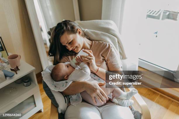 mother feeding her baby - feeding hungry stock pictures, royalty-free photos & images