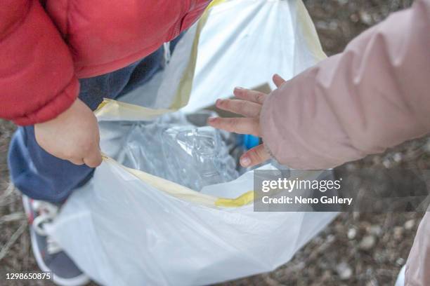 children picking up trash in the forest - reciclar stock pictures, royalty-free photos & images