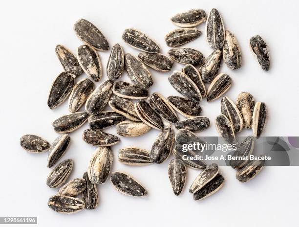 group of sunflower seeds in shell and salt on a white background. - sunflower seed stock pictures, royalty-free photos & images