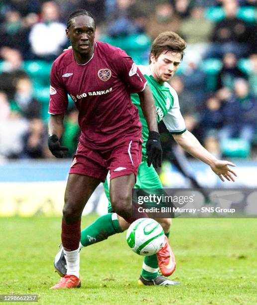 V HEARTS .EASTER ROAD - EDINBURGH .David Obua holds off Hibs' Lewis Stevenson