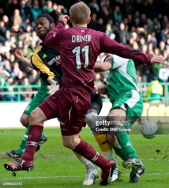 V HEARTS .EASTER ROAD - EDINBURGH .Yves Ma-Kalambay comes for the ball but fails to stop Hearts' Christian Nade from scoring