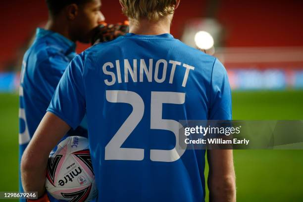 Huddersfield Town players warm up wearing a shirt with 'Sinnott 25' on the back in memory of ex-Huddersfield Town player, Jordan Sinnott, a year...