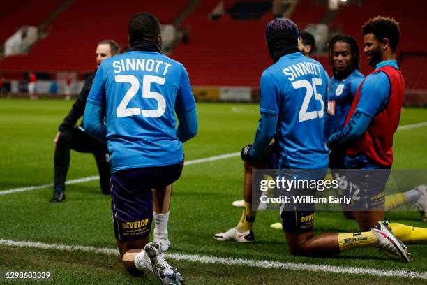 Huddersfield Town players warm up wearing a shirt with 'Sinnott 25' on the back in memory of ex-Huddersfield Town player, Jordan Sinnott, a year...