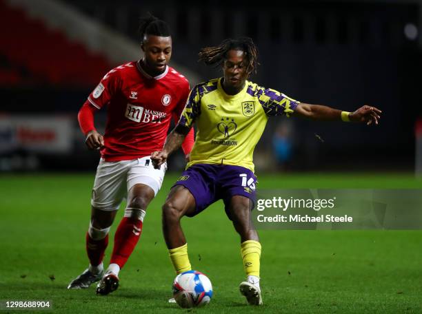 Rolando Aarons of Huddersfield Town is challenged by Antoine Semenyo of Bristol City during the Sky Bet Championship match between Bristol City and...