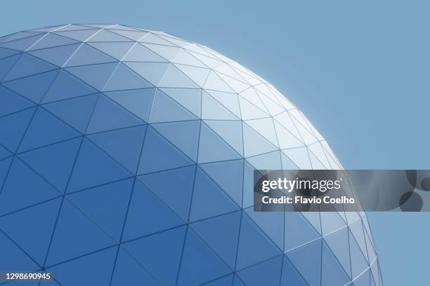 geodesic dome against blue sky abstract background - dôme photos et images de collection