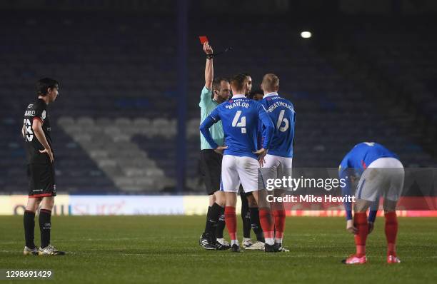Jack Whatmough of Portsmouth FC is shown a red card by referee Sam Purkiss during the Sky Bet League One match between Portsmouth and Lincoln City at...